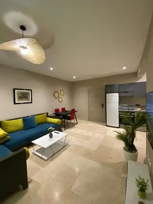 a living room with a blue couch and a table at Red city charm - city center apartment in Marrakech