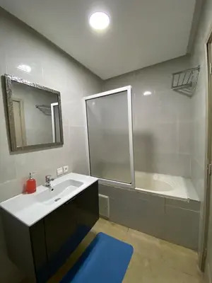 a bathroom with a sink and a bath tub at Red city charm - city center apartment in Marrakech