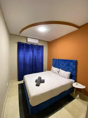 a bed with a blue headboard in a room at Nice apartment in Marrakech center in Marrakech