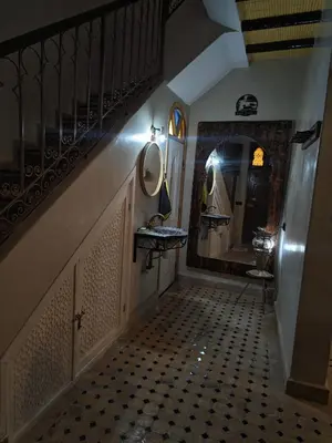 a hallway with a bathroom with a sink and mirror at Riad Dar Barka Privatisé 3 chambres in Marrakech