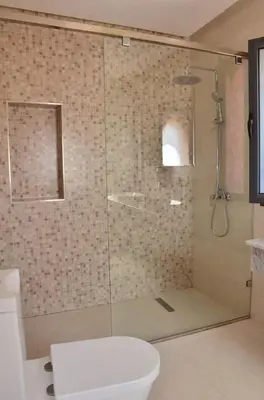 a bathroom with a glass shower with a toilet at Villa à la palmeraie in Marrakech