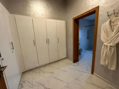 a bathroom with white cabinets and a tiled floor at Villa à la palmeraie in Marrakech