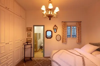 a bedroom with a bed and a chandelier at Riad Cosy in Marrakech