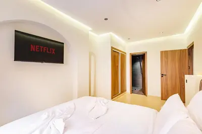 a bedroom with a bed and a television on the wall at Sweet Clarity Swimming pool and Parking in Marrakech