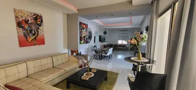 a living room with a couch and a table at Villa Maison Dar Sukar in El Caïd Omar