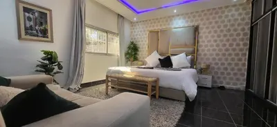a hotel room with a bed and a couch at Villa Maison Dar Sukar in El Caïd Omar
