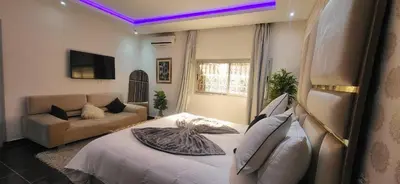 a living room with a bed and a couch at Villa Maison Dar Sukar in El Caïd Omar