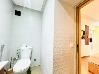 a white bathroom with a toilet and a shower at Lovely studio 4th floor No Elevator in El Gouassem