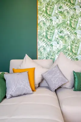 a couch with pillows on it in a room at Charming 1-BR with Terrace, AC, Parking-City Center in Marrakech