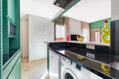 a kitchen with a washer and dryer in a room at Charming 1-BR with Terrace, AC, Parking-City Center in Marrakech
