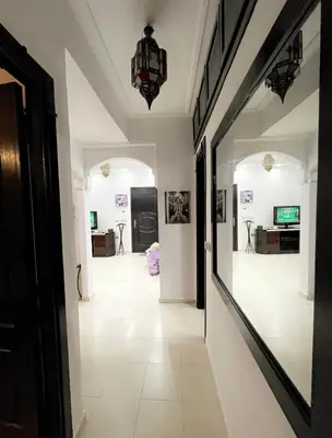 a hallway with a large mirror and a room at Spacious 2BR with Parking & Local Life & Centra in Marrakech