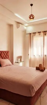 a bedroom with a large bed in a room at Moderne appart NEUF Proche Aéroport et Gueliz in Marrakech