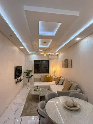 a living room with a couch and a table at Moderne appart NEUF Proche Aéroport et Gueliz in Marrakech