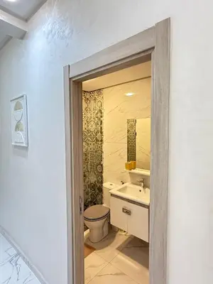 a bathroom with a toilet and a sink at Moderne appart NEUF Proche Aéroport et Gueliz in Marrakech