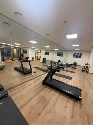 a gym with pilates equipment in a large mirror at Beautiful Apartment in Guéliz Pools & Jacuzzi in Marrakech
