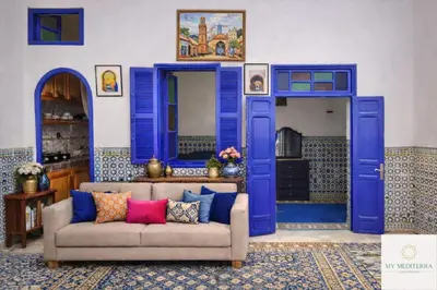 a living room with blue doors and a couch at Riad Le Sultana in Marrakech