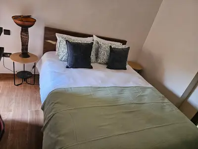a bed with four pillows on it in a room at Appart Cosy et confort en plein centre Marrakech in Marrakech