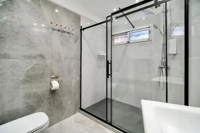 a bathroom with a shower and a toilet at Downtown Cozy Apartment with Panoramic View in Marrakech