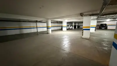 an empty parking garage with yellow and blue stripes at 10 min from Stadium AFCON Green Table Loft in Marrakech