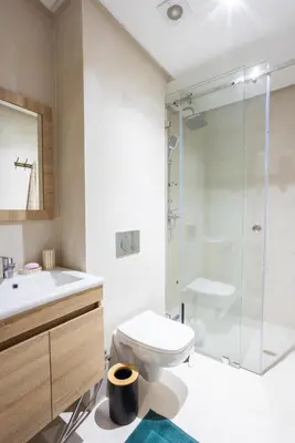 a bathroom with a toilet sink and a shower at Luxurious and Cozy Apartment with Parking and View in Marrakech