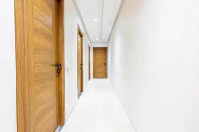 an empty hallway with white walls and wooden doors at Luxurious and Cozy Apartment with Parking and View in Marrakech