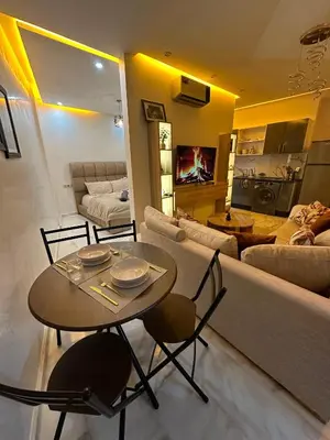 a living room with a table and a couch at Appartement plaza in Marrakech