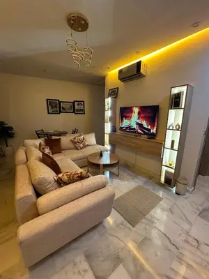 a living room with a couch and a tv at Appartement plaza in Marrakech
