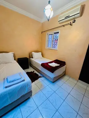 a bedroom with two beds and a window at B&B Lina Stay Marrakech in Marrakech
