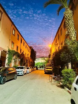 a parking lot with cars parked next to buildings at B&B Lina Stay Marrakech in Marrakech