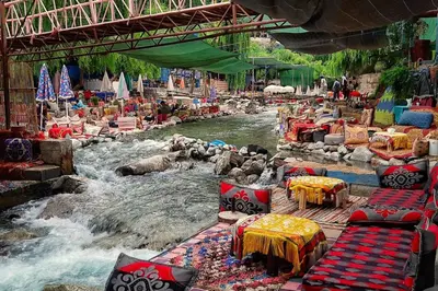 a river with tables and chairs in the middle at B&B Lina Stay Marrakech in Marrakech