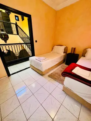 two beds in a room with a balcony at B&B Lina Stay Marrakech in Marrakech