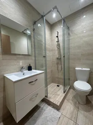 a bathroom with a shower and a sink and a toilet at Prestigia Appartment Golf & 3 Pools in Marrakech