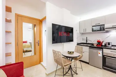 a kitchen with a small table and chairs in a room at Studio chic et cosy au cœur de Guéliz in Marrakech