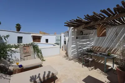 a patio with a fence and a swimming pool at RIAD BAB OUCHKA & Heated pool in Oulad Akkou