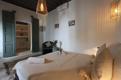 a bedroom with a large bed with teddy bears on it at RIAD BAB OUCHKA & Heated pool in Oulad Akkou