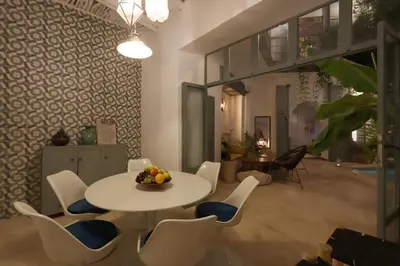 a dining room with a white table and chairs at RIAD BAB OUCHKA & Heated pool in Oulad Akkou