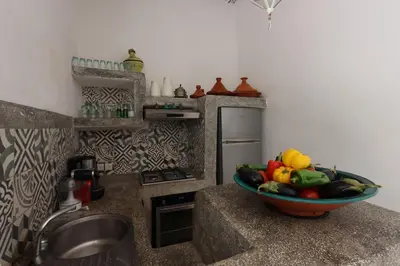 a bowl of fruit on a counter in a kitchen at RIAD BAB OUCHKA & Heated pool in Oulad Akkou