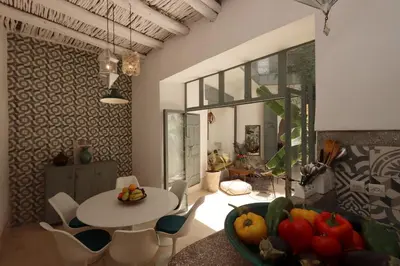 a dining room with a table and a bowl of fruit at RIAD BAB OUCHKA & Heated pool in Oulad Akkou