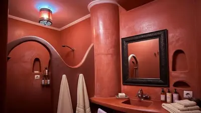 a bathroom with a sink and a mirror at Riad Lana Marrakech - Dar el Bacha Luxury Suites in Marrakech