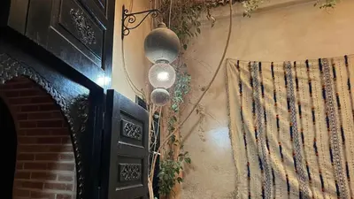 a corner of a room with a door with curtains at Riad Lana Marrakech - Dar el Bacha Luxury Suites in Marrakech