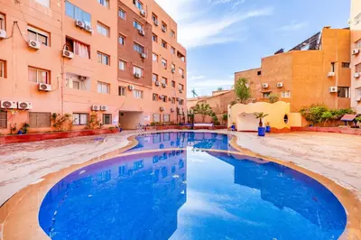a swimming pool in a courtyard of a building at Le Nid de Guéliz Private terrace and silence in Marrakech