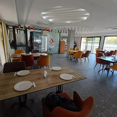 a dining room with tables and chairs and tablesktop at Cozy flat near airport in Marrakech