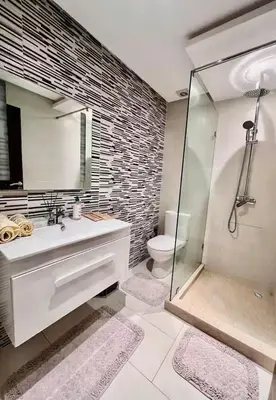 a bathroom with a shower and a sink and a toilet at Jnane El Ali 3 in Marrakech