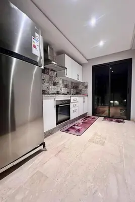 a kitchen with a stainless steel refrigerator and appliances at Jnane El Ali 3 in Marrakech