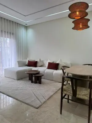 a living room with a white couch and tables at Cozy apartment Kenza Menara Garden 2 - 2 rooms in Marrakech