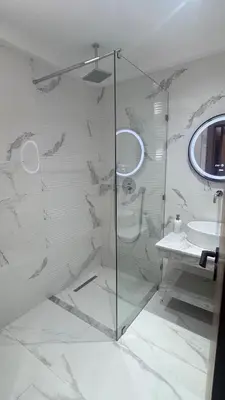 a bathroom with a glass shower and a sink at Cozy apartment Kenza Menara Garden 2 - 2 rooms in Marrakech