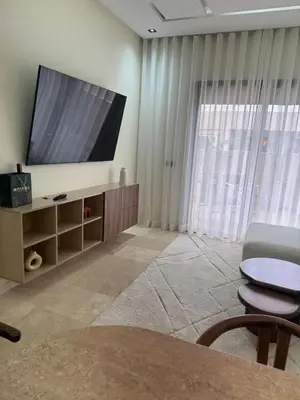 a living room with a large flat screen tv at Cozy apartment Kenza Menara Garden 2 - 2 rooms in Marrakech