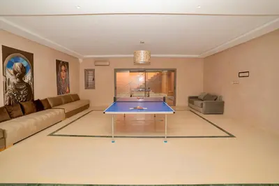 a living room with a ping pong table in it at Villa Akenza piscine privée Marrakesh in El Rhechat