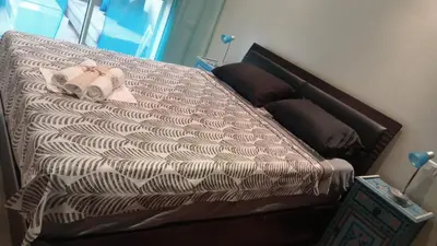 a bed with a brown and white comforter at Marrakech garden lilla in Marrakech