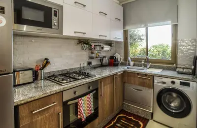 a kitchen with a sink and a stove top oven at Prestigia Jade in Marrakech